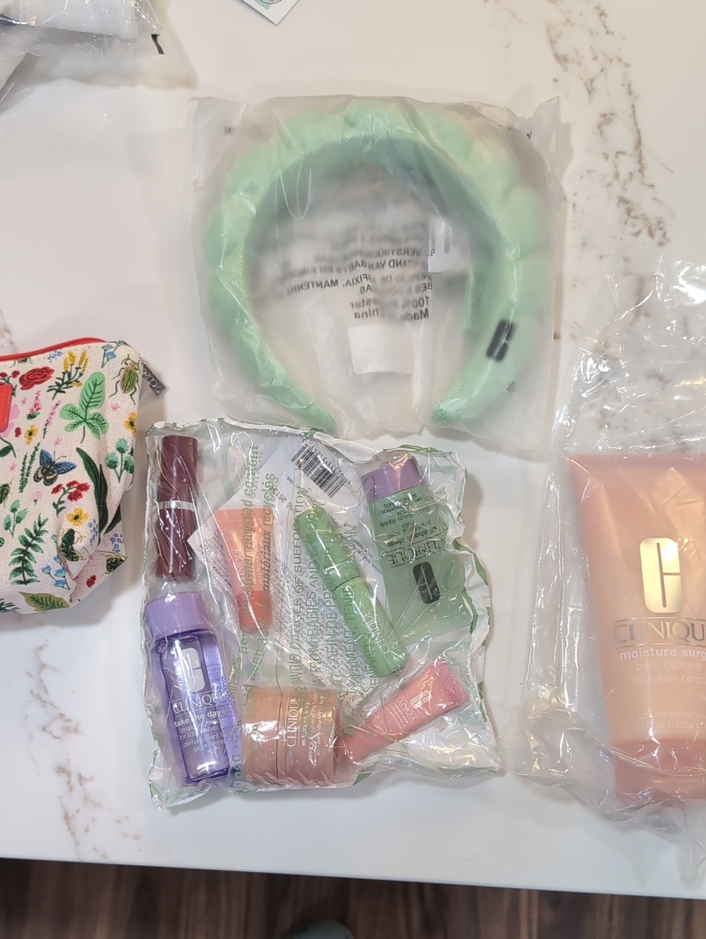New Clinique Bag, Headband, Full Size Body Moisturizer and 7 Piece Trial Size.